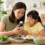 Parent and child comparing a liquid children's multivitamin with iron alongside balanced foods