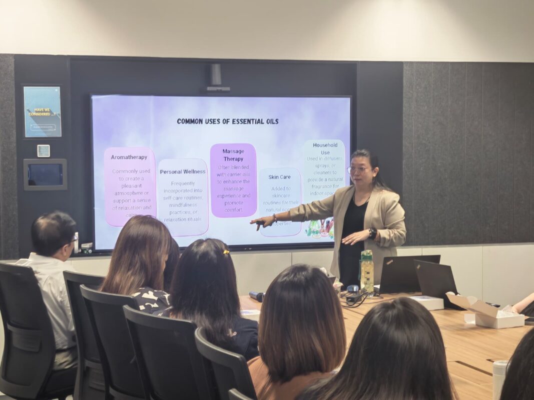 A ThreeLeaf facilitator leading an aromatherapy workshop, viewed from behind the audience
